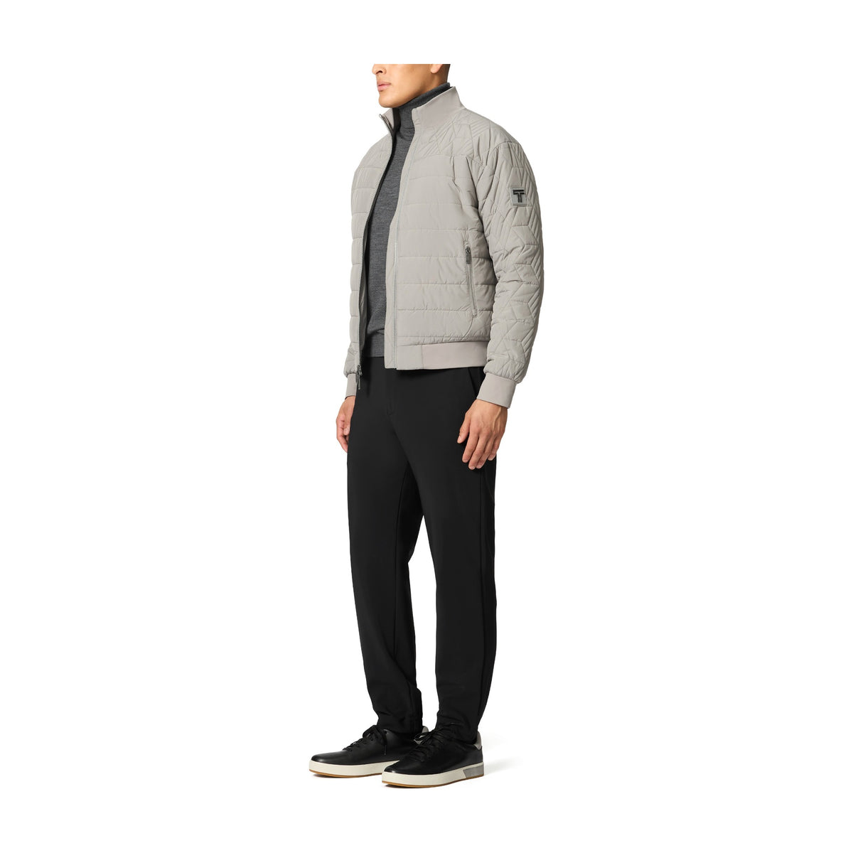 Tumi Men's Packable Puffer Jacket in Grey, three-quarter view on model