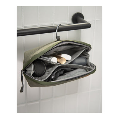 Peak Design Wash Pouch Small Sage hanging open with toiletries