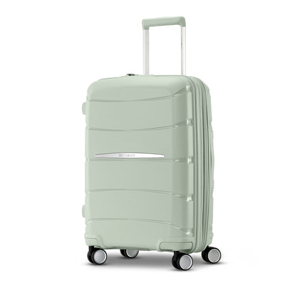 Samsonite Outline Pro sage 22" carry-on hardside spinner, three-quarter front view, telescoping handle extended, horizontal wave-ribbed shell