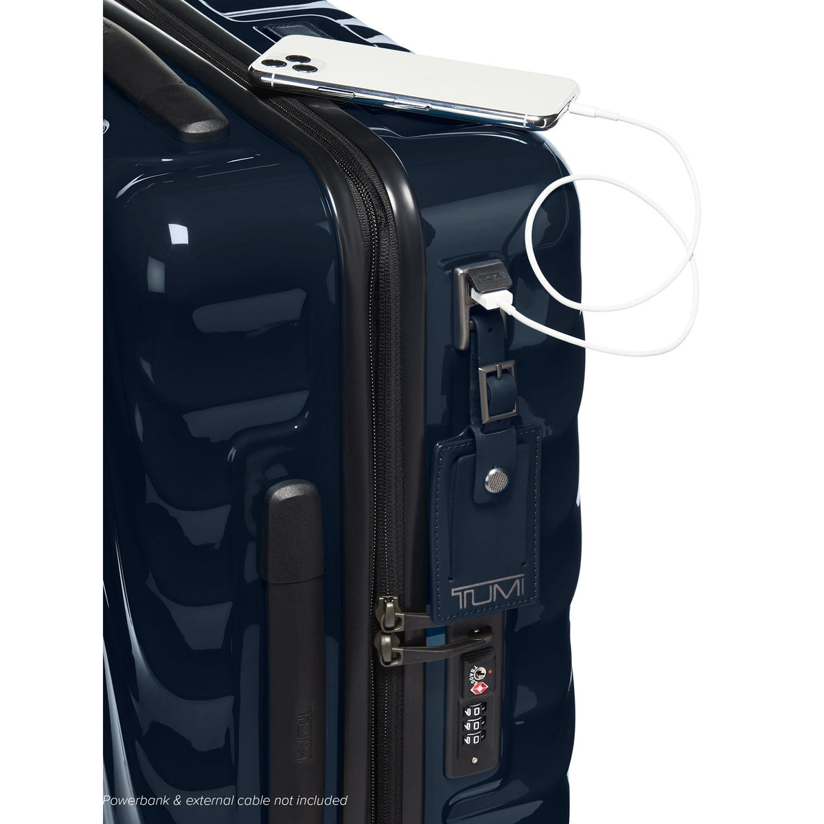 Tumi 19 Degree Continental navy expandable hardside carry-on, USB port close-up with a phone charging on top