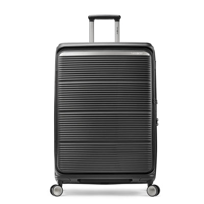 Featured image: Samsonite Paralux black large checked hardside spinner, front view, telescoping handle slightly raised, horizontal ribbed shell