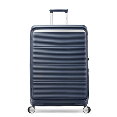 Samsonite Paralux midnight navy large checked hardside spinner, front view, telescoping handle slightly raised, horizontal ribbed shell