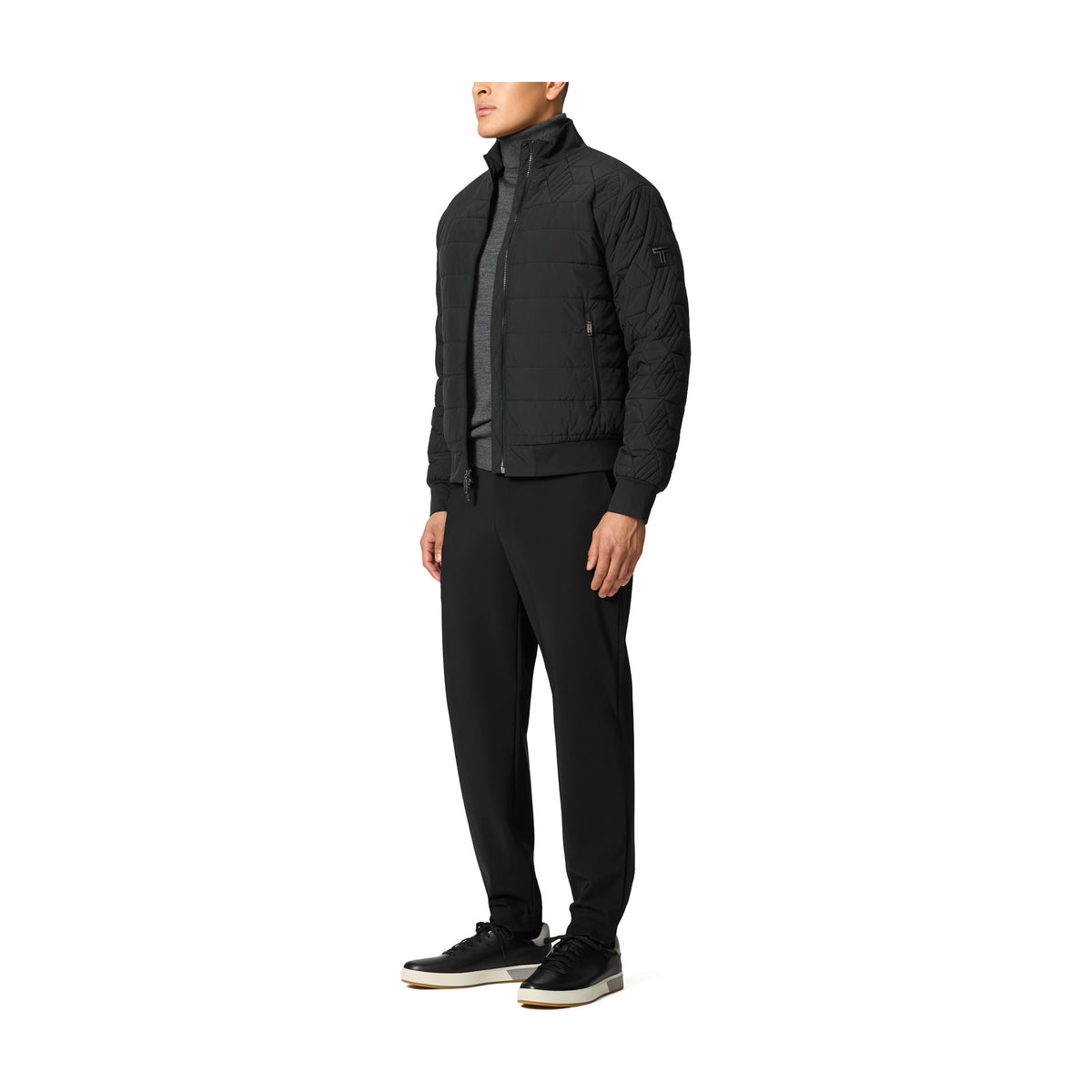Tumi Men's Packable Puffer Jacket in Black, three-quarter view on model