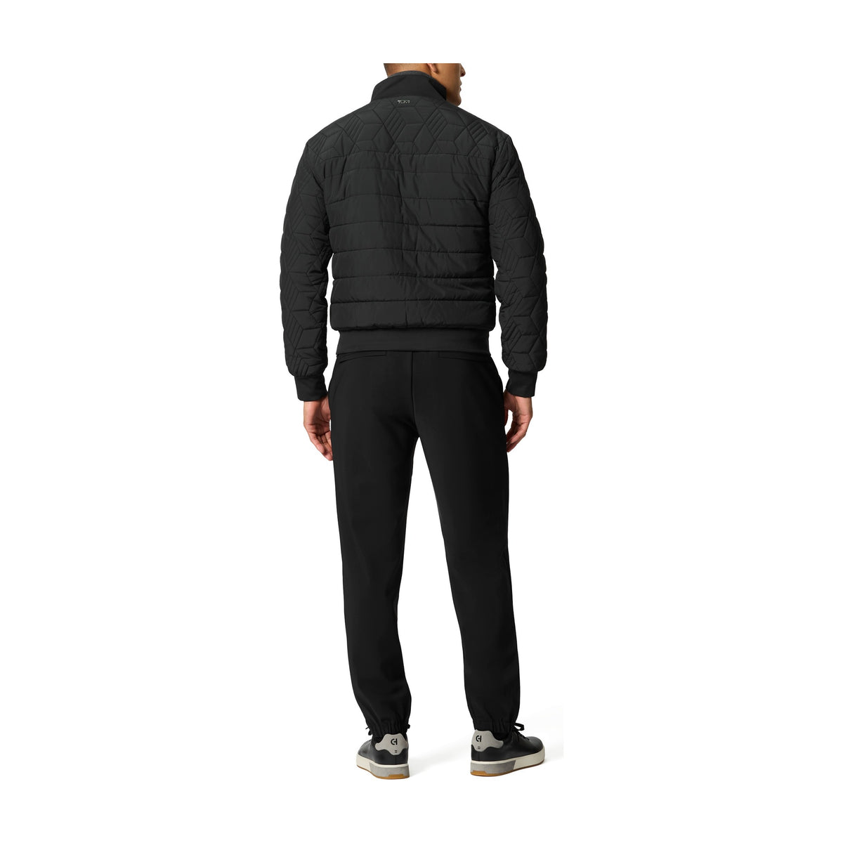 Tumi Men's Packable Puffer Jacket in Black, back view on model