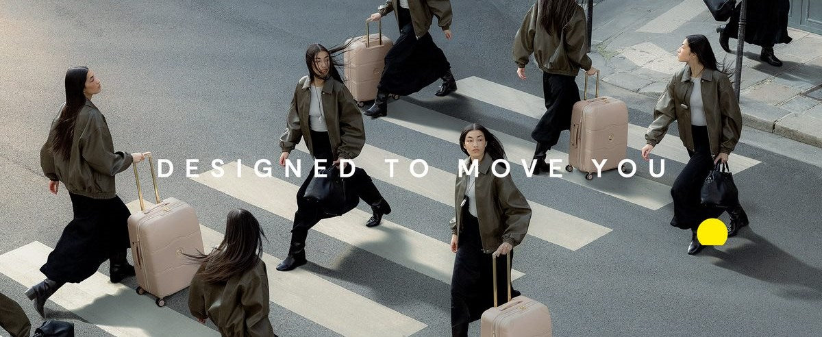 Delsey Paris travelers crossing a city street with rolling luggage